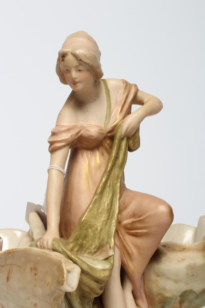 ROYAL DUX PORCELAIN ART NOUVEAU FIGURAL CENTREPIECE modelled as a young maiden standing between a Image