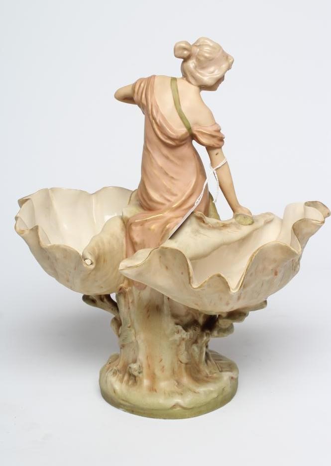 ROYAL DUX PORCELAIN ART NOUVEAU FIGURAL CENTREPIECE modelled as a young maiden standing between a Image