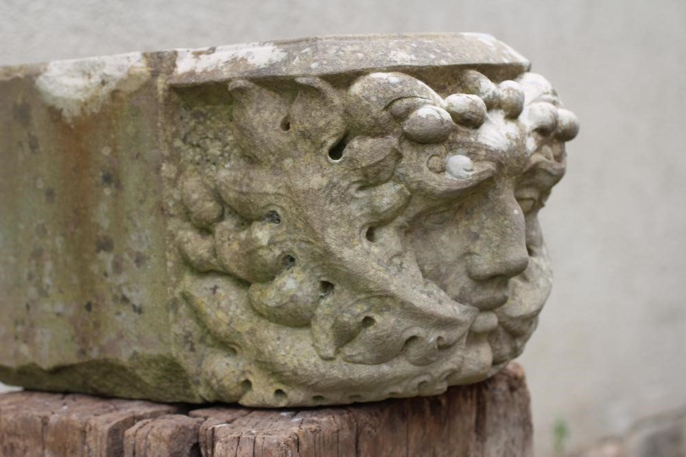 A CARVED SANDSTONE GREEN MAN CORBEL, finely executed and raised on a wood plinth, corbel 15 1/4" x 9 Image