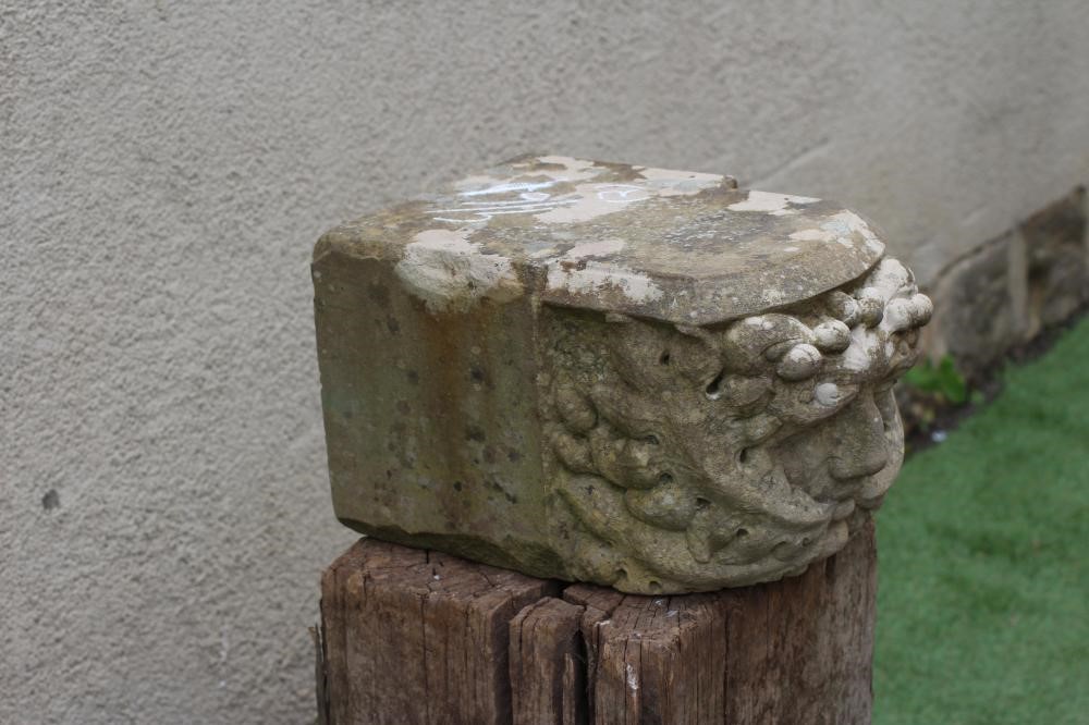 A CARVED SANDSTONE GREEN MAN CORBEL, finely executed and raised on a wood plinth, corbel 15 1/4" x 9 Image