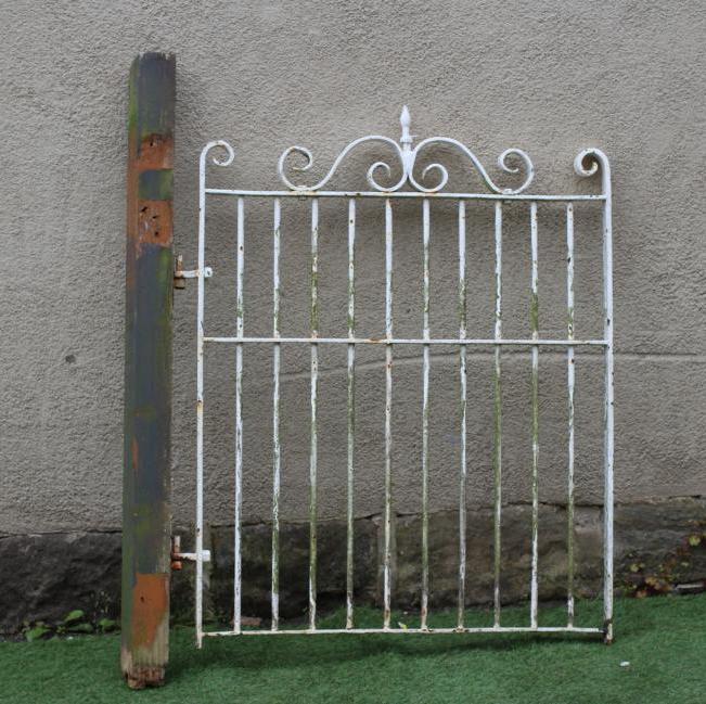 A CAST AND WROUGHT IRON PEDESTRIAN BARRED GATE, the scrolled surmount with turned finial, 32 1/4" Image