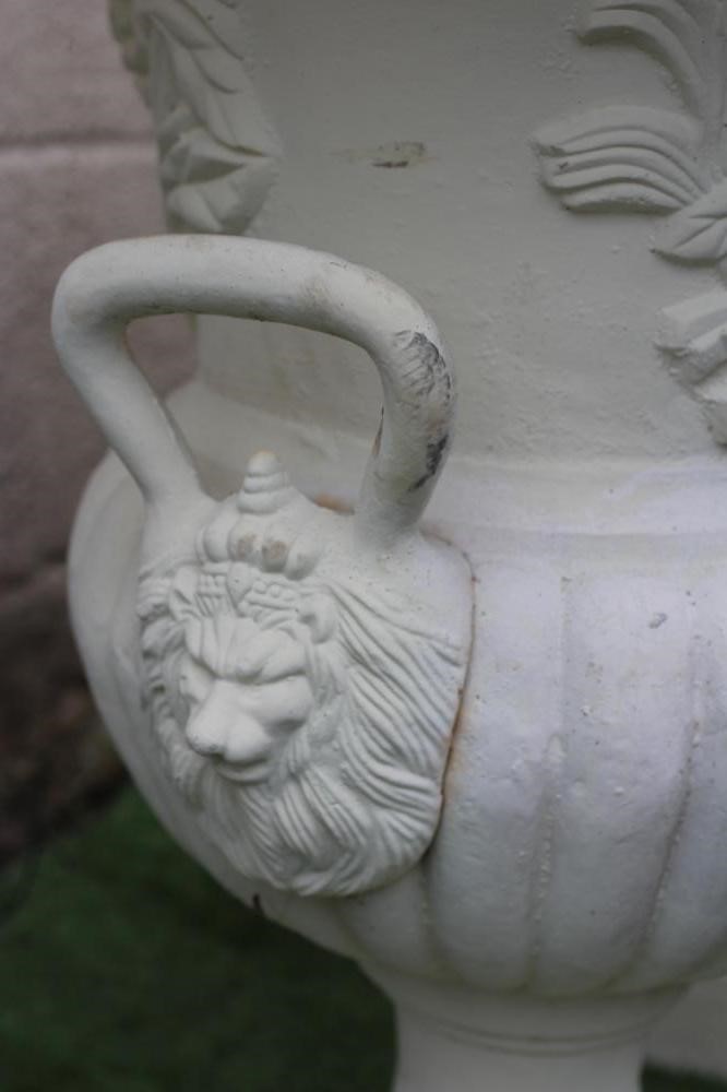 A PAIR OF LARGE CAST IRON URNS of half fluted campana form with lion mask loop handles Image