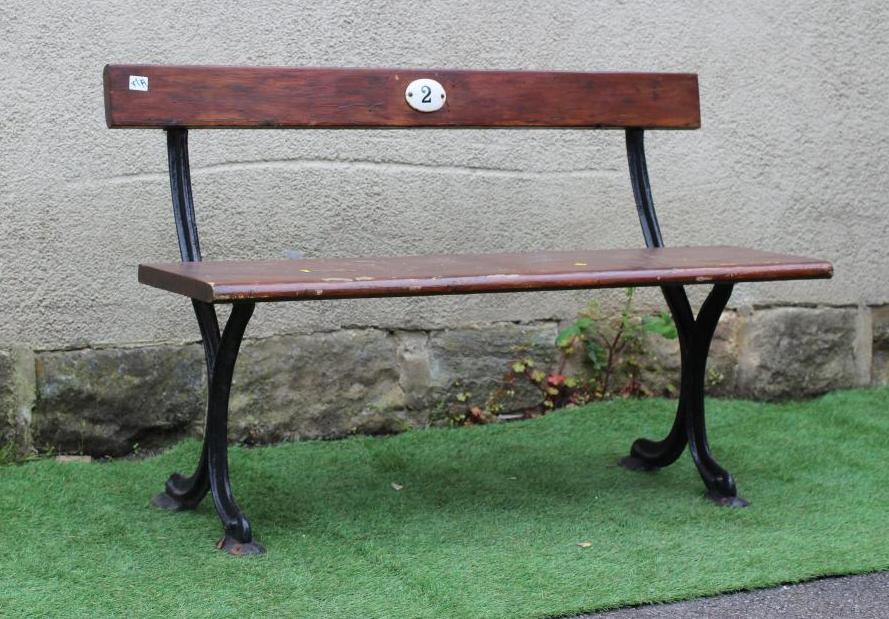 A SMALL RAILWAY BENCH, of plain moulded form with single plank seat and downswept feet, the back Image