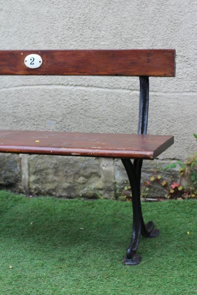 A SMALL RAILWAY BENCH, of plain moulded form with single plank seat and downswept feet, the back Image