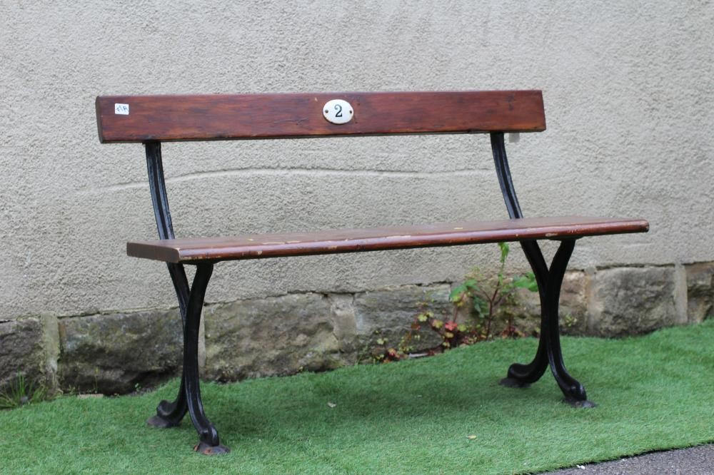 A SMALL RAILWAY BENCH, of plain moulded form with single plank seat and downswept feet, the back Image