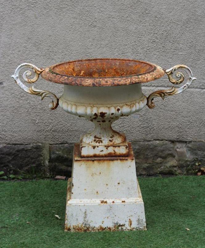 A VICTORIAN CAST IRON URN of shallow half fluted campana form with acanthus sheathed scroll handles Image