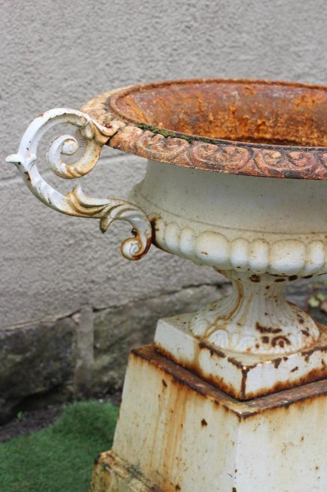 A VICTORIAN CAST IRON URN of shallow half fluted campana form with acanthus sheathed scroll handles Image