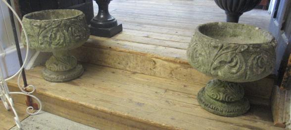 A PAIR OF CAST STONE URNS Image