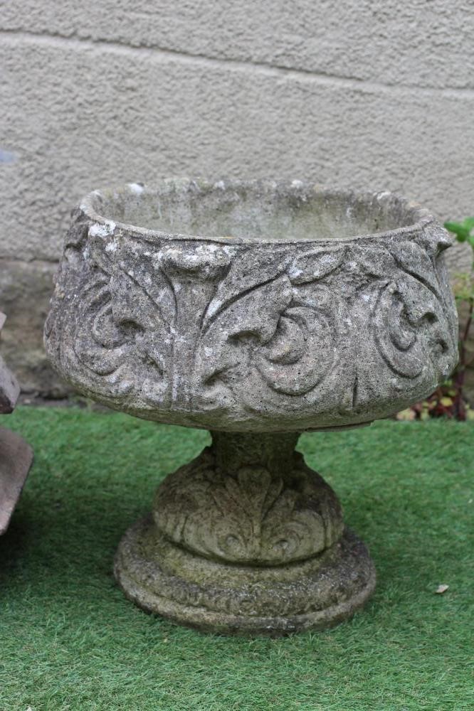 A PAIR OF CAST STONE URNS Image