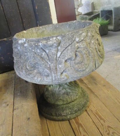 A PAIR OF CAST STONE URNS Image