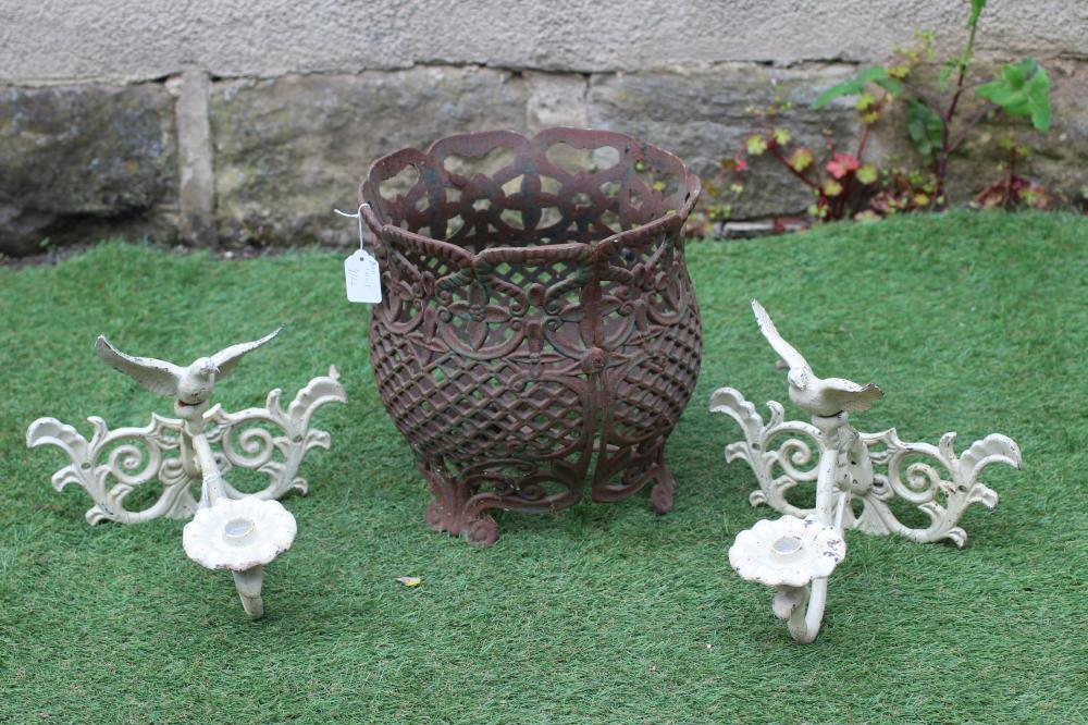 A CAST IRON JARDINIERE of baluster form pierced with a floral banded rim over a trellis body Image