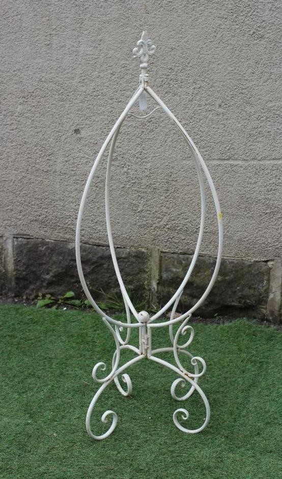 A CAST IRON JARDINIERE of baluster form pierced with a floral banded rim over a trellis body Image