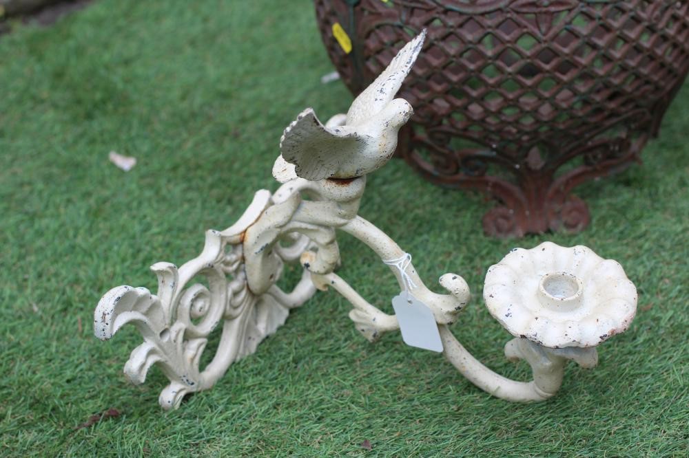 A CAST IRON JARDINIERE of baluster form pierced with a floral banded rim over a trellis body Image