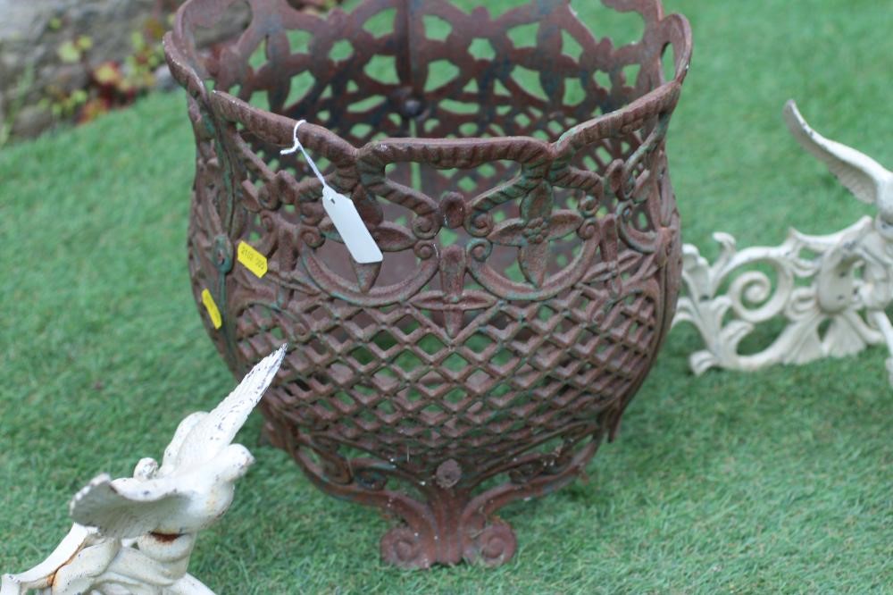 A CAST IRON JARDINIERE of baluster form pierced with a floral banded rim over a trellis body Image