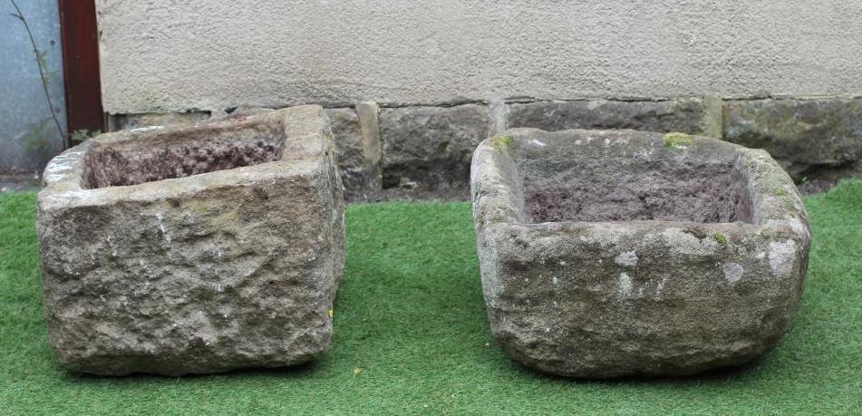 A MATCHED PAIR OF SANDSTONE TROUGHS of rough hewn oblong form, 23 1/2" x 20 1/2" x 13 1/2" (Est. Image