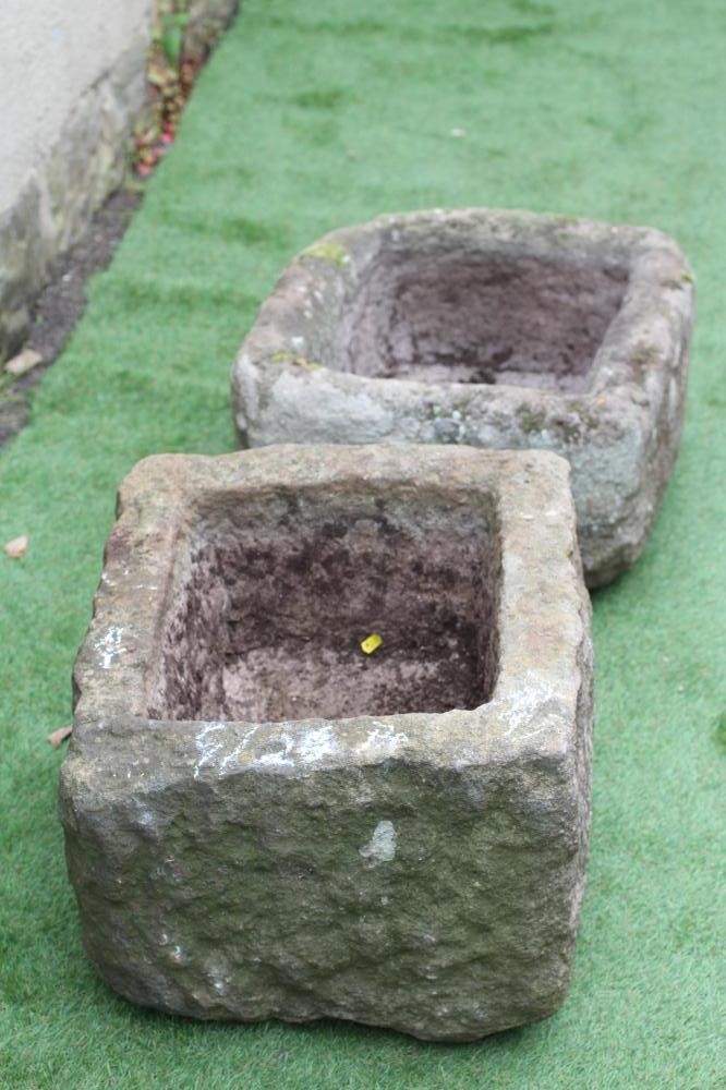 A MATCHED PAIR OF SANDSTONE TROUGHS of rough hewn oblong form, 23 1/2" x 20 1/2" x 13 1/2" (Est. Image