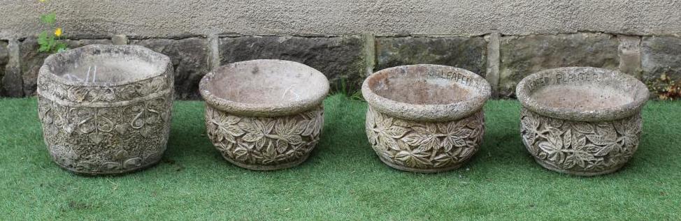 A SET OF THREE CAST STONE CIRCULAR PLANTERS with leaf moulded sides, 14 1/4" x 9", together with a Image