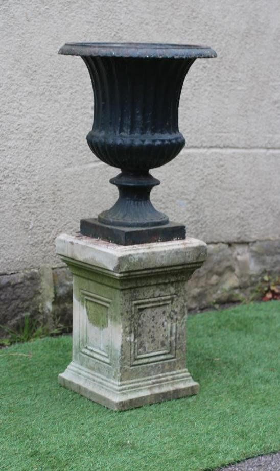 A VICTORIAN CAST IRON URN of fluted campana form with square base, 15 1/2" x 18 3/4", on associated Image