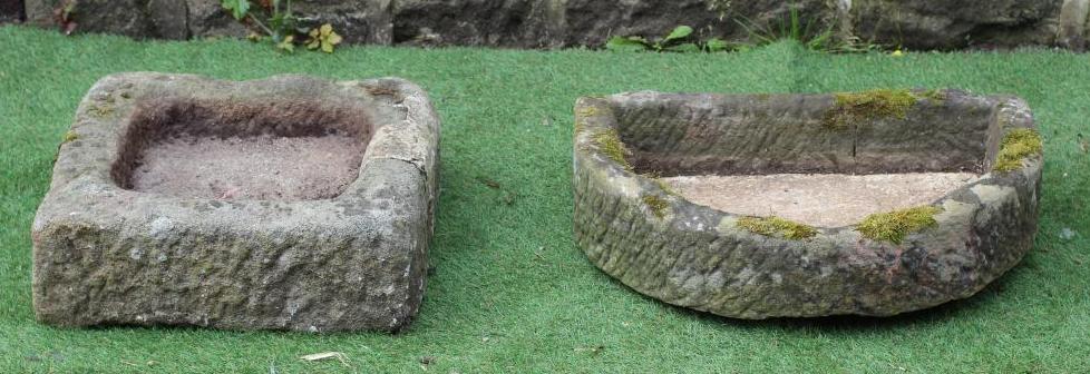 A SANDSTONE TROUGH of rough hewn D form, 25" x 15 1/2" x 5 1/2", together with a similar shallow Image