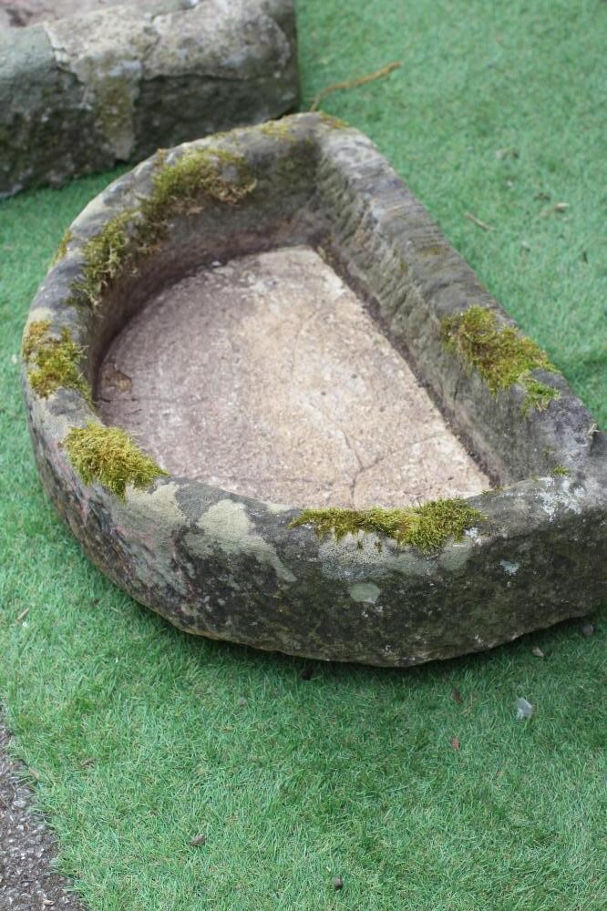 A SANDSTONE TROUGH of rough hewn D form, 25" x 15 1/2" x 5 1/2", together with a similar shallow Image