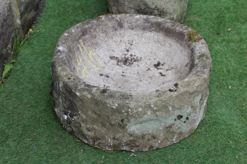 A SMALL SANDSTONE TROUGH of rough hewn circular form, 21 1/2" x 8 1/2", together with a similar Image