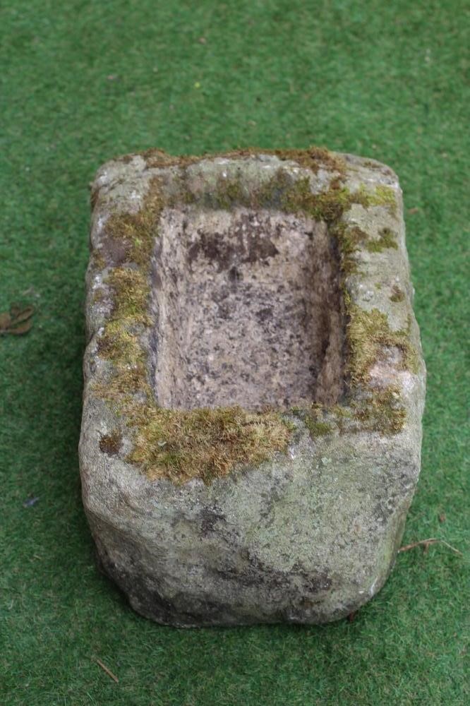 A SMALL SANDSTONE TROUGH of rough hewn circular form, 21 1/2" x 8 1/2", together with a similar Image