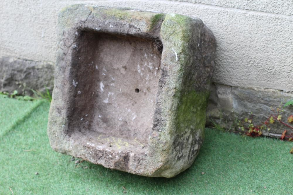A SANDSTONE TROUGH of rough hewn square form, 22" x 20 1/2" x 11 1/2" (Est. plus 24% premium inc. Image