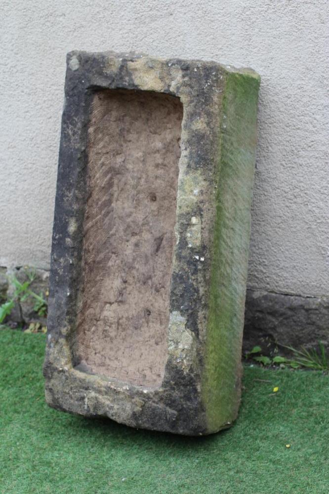 A SANDSTONE TROUGH of rough hewn oblong form, 18" x 10 1/2" x 36" (Est. plus 24% premium inc. VAT) Image