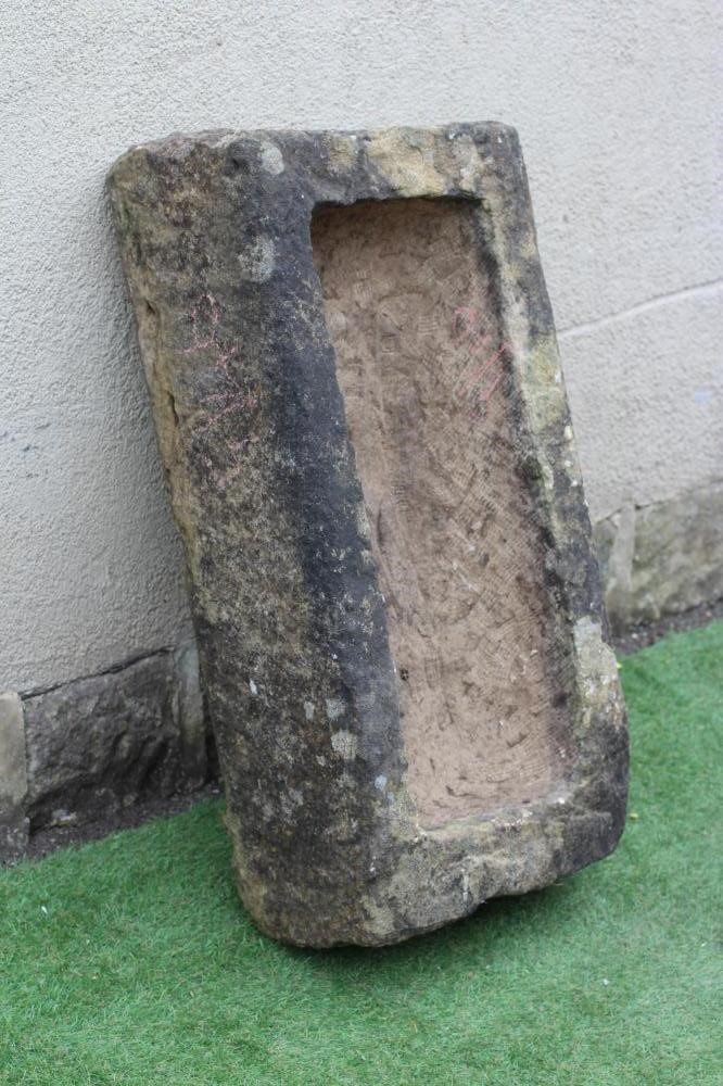 A SANDSTONE TROUGH of rough hewn oblong form, 18" x 10 1/2" x 36" (Est. plus 24% premium inc. VAT) Image