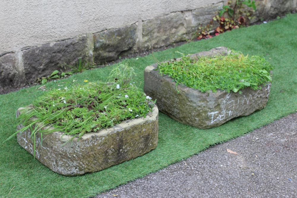 A MATCHED PAIR OF SANDSTONE TROUGHS of well cut D form, 22 1/2" x 16 1/2" x 7 1/2" (approx.) (Est. Image