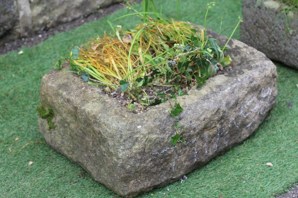 A SMALL SANDSTONE TROUGH of well cut D form, 19" x 15" x 7", together with another rough hewn oblong Image