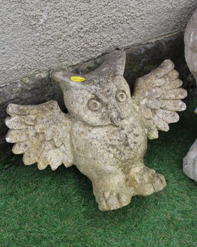 A CARVED SANDSTONE OWL, modelled resting on a tree stump and clutching a mouse in its claws, 16 1/2" Image