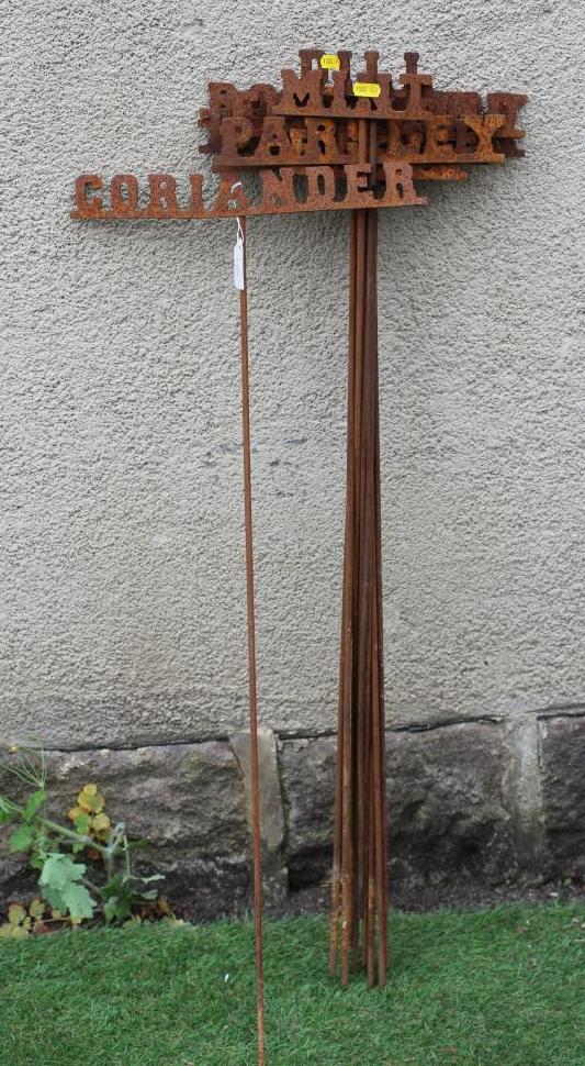 A SET OF TWELVE WROUGHT IRON INDIVIDUAL HERB MARKERS, on poles, 6" - 13 1/2" x 36" (Est. plus 24% Image