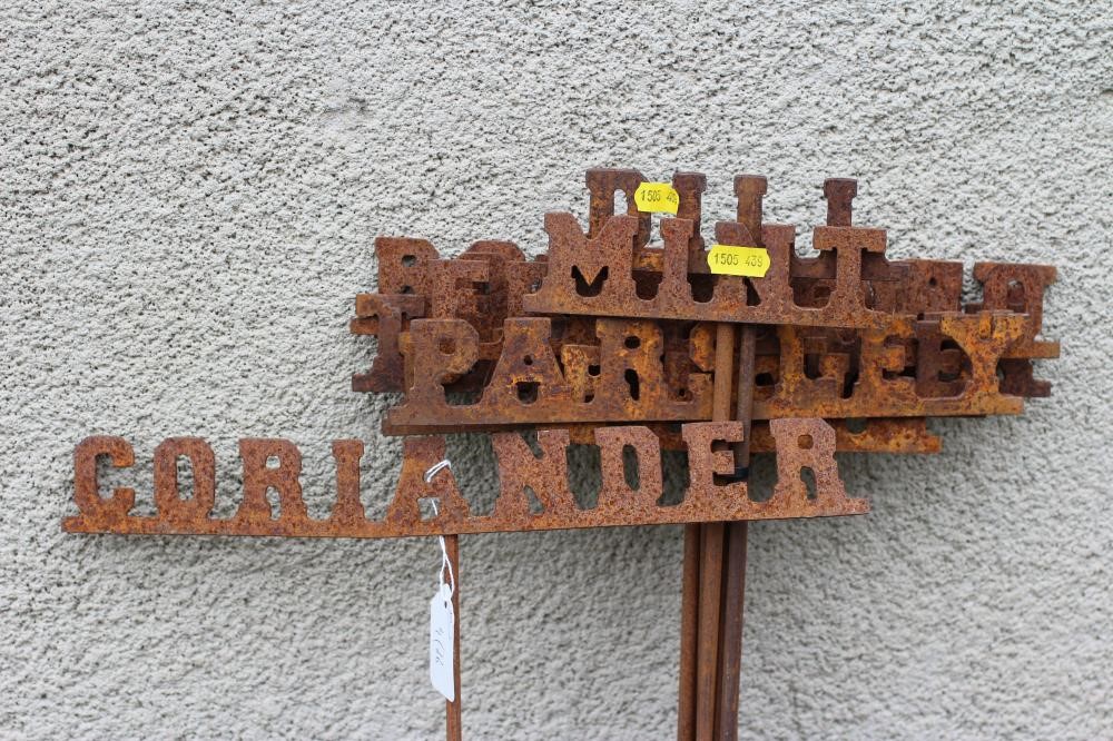 A SET OF TWELVE WROUGHT IRON INDIVIDUAL HERB MARKERS, on poles, 6" - 13 1/2" x 36" (Est. plus 24% Image