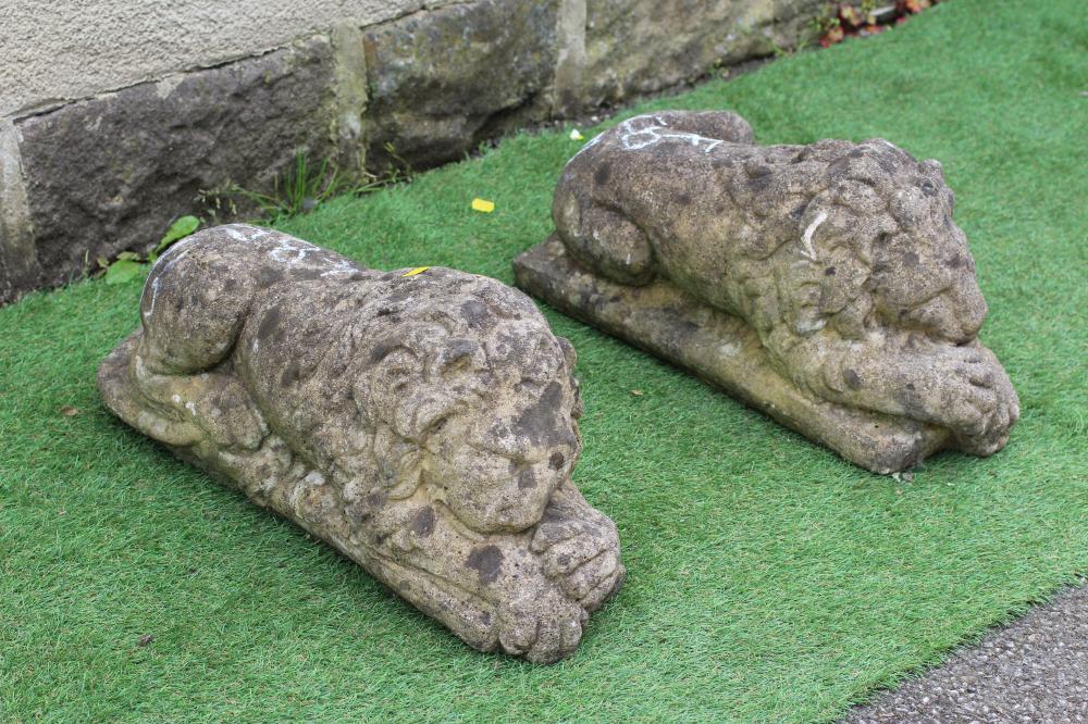 A PAIR OF CAST COMPOSITION LIONS AFTER CANOVA, on oblong bases, 23 1/2" wide (Est. plus 24% premium Image