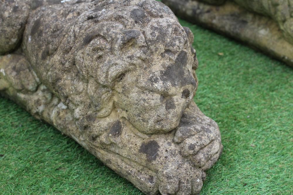 A PAIR OF CAST COMPOSITION LIONS AFTER CANOVA, on oblong bases, 23 1/2" wide (Est. plus 24% premium Image