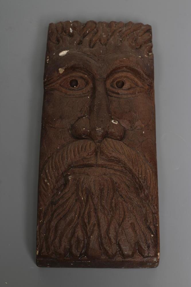 A PAIR OF CARVED SANDSTONE GREEN MAN WALL MASKS of shallow oblong form, stained brown, 13 1/2" x 5 Image