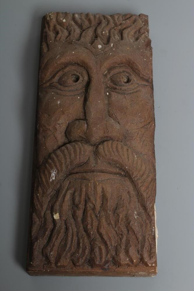 A PAIR OF CARVED SANDSTONE GREEN MAN WALL MASKS of shallow oblong form, stained brown, 13 1/2" x 5 Image