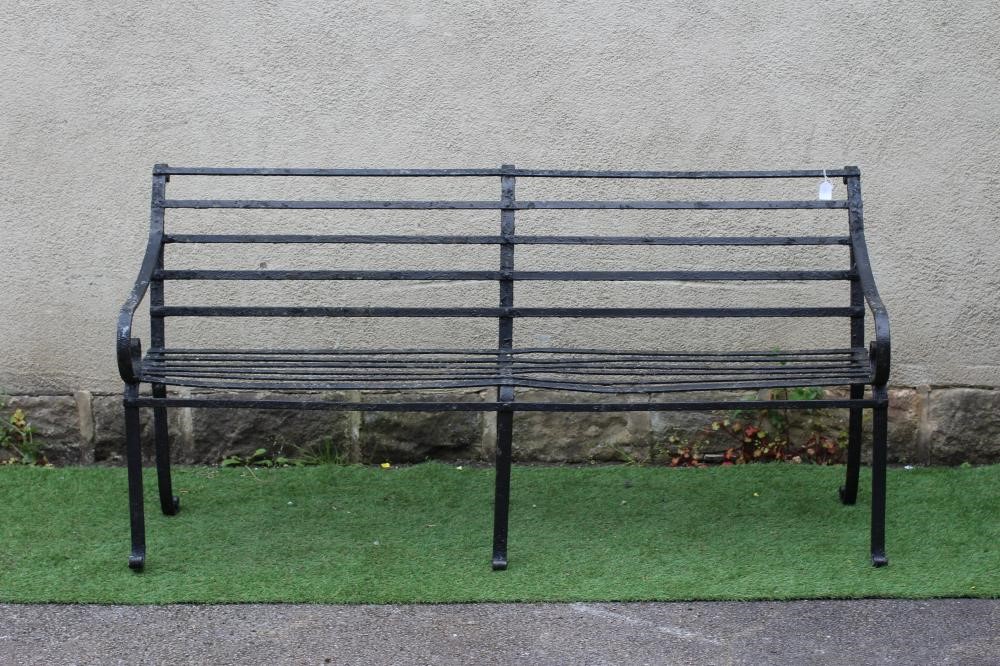A VICTORIAN WROUGHT IRON STRAPWORK GARDEN BENCH with scrolled arms and feet, 72" x 15 1/2" x 35 1/4" Image
