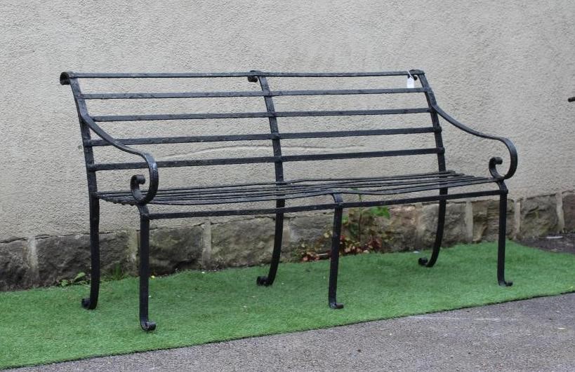 A VICTORIAN WROUGHT IRON STRAPWORK GARDEN BENCH with scrolled arms and feet, 72" x 15 1/2" x 35 1/4" Image