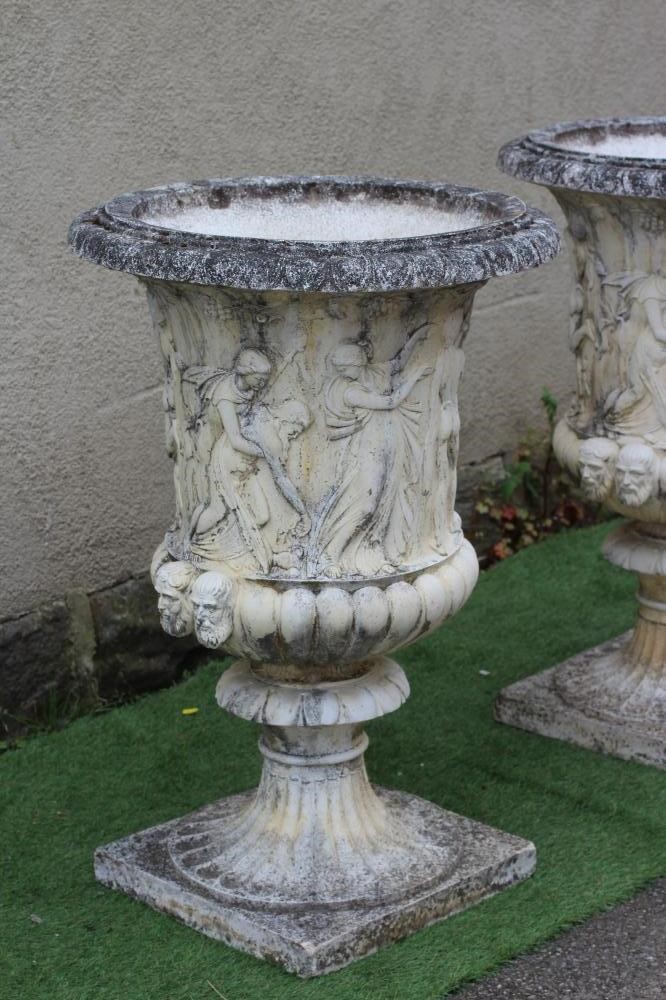 A PAIR OF LARGE CAST STONE MEDICI STYLE URNS, with frieze of classical figures over a fluted base, Image