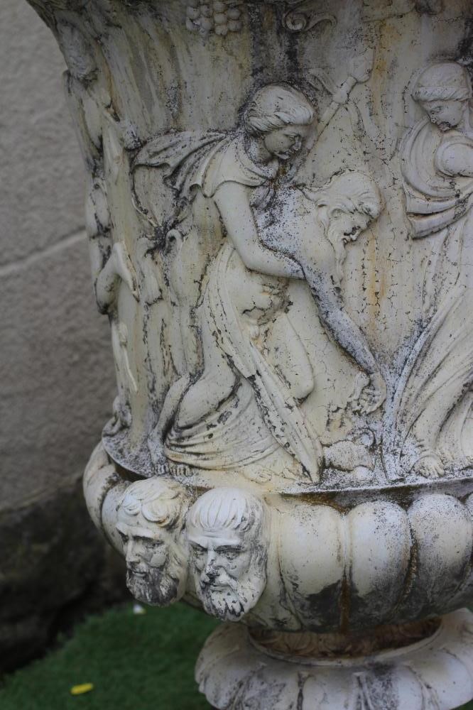 A PAIR OF LARGE CAST STONE MEDICI STYLE URNS, with frieze of classical figures over a fluted base, Image