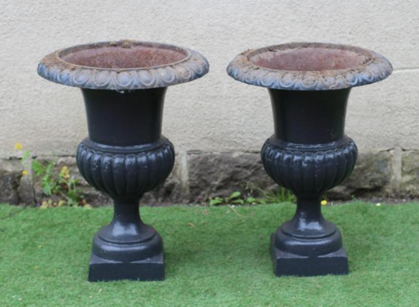 A PAIR OF LARGE CAST IRON URNS, of half fluted campana form, on square base, 22" wide, 31" high Image