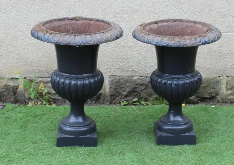 A PAIR OF LARGE CAST IRON URNS, of half fluted campana form, on square base, 22" wide, 31" high Image