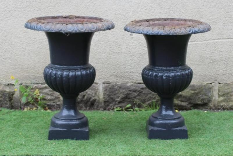 A PAIR OF LARGE CAST IRON URNS, of half fluted campana form, on square base, 22" wide, 31" high Image