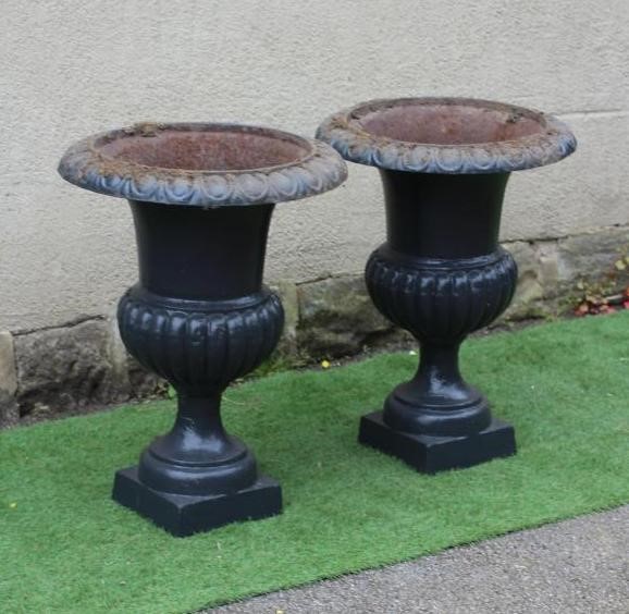 A PAIR OF LARGE CAST IRON URNS, of half fluted campana form, on square base, 22" wide, 31" high Image