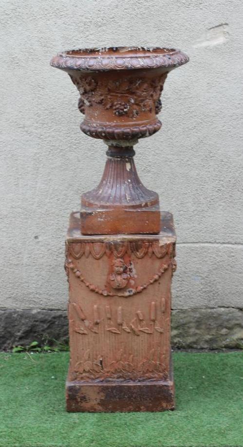 A SALTGLAZE STONEWARE URN of half fluted campana form with frieze of trailing vine in relief Image