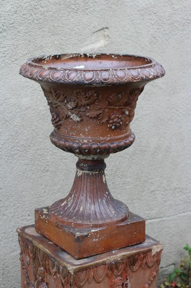 A SALTGLAZE STONEWARE URN of half fluted campana form with frieze of trailing vine in relief Image