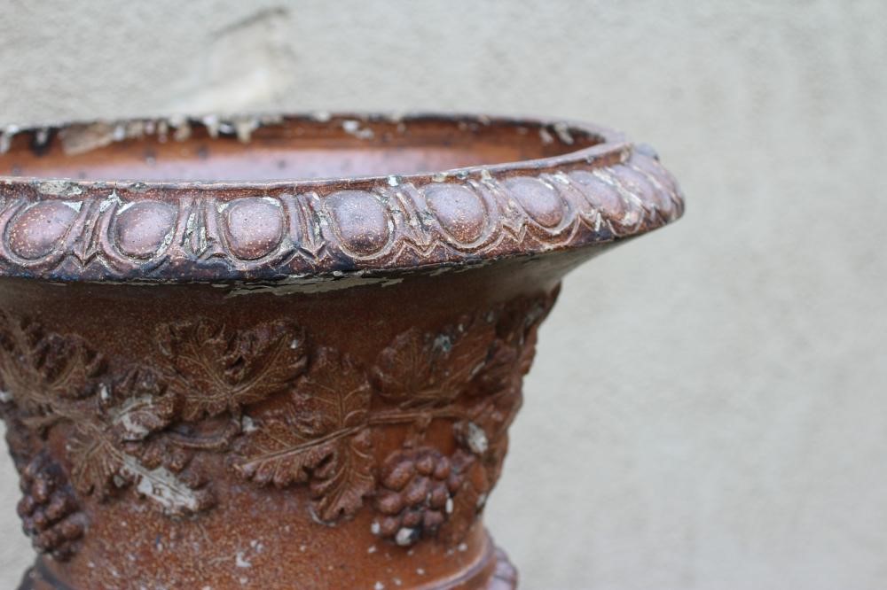 A SALTGLAZE STONEWARE URN of half fluted campana form with frieze of trailing vine in relief Image