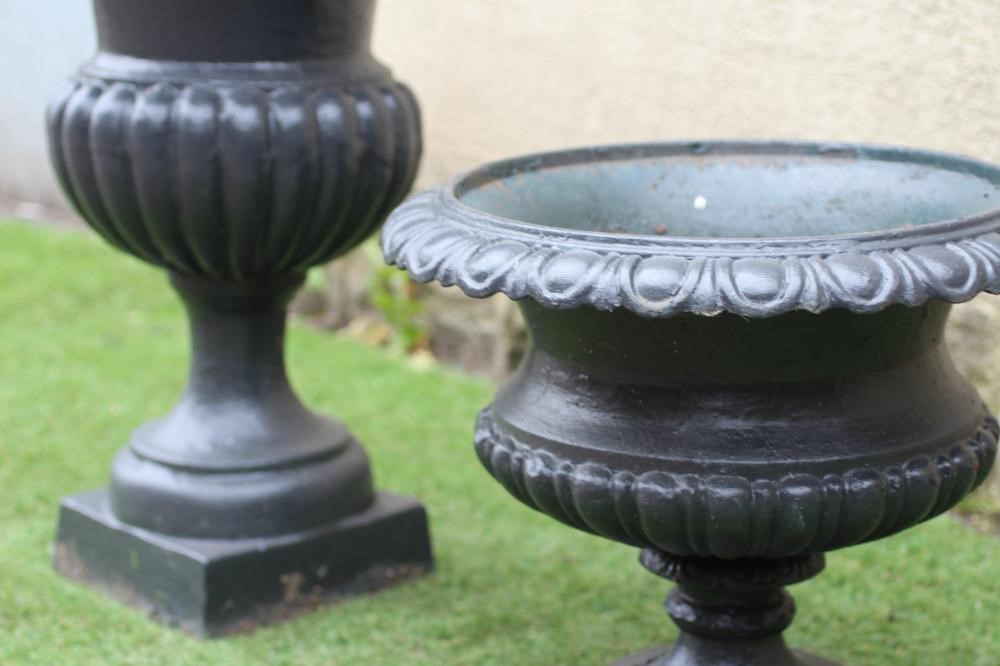 A LARGE CAST IRON URN of half fluted campana form with square base, 22" wide, 31" high, together Image